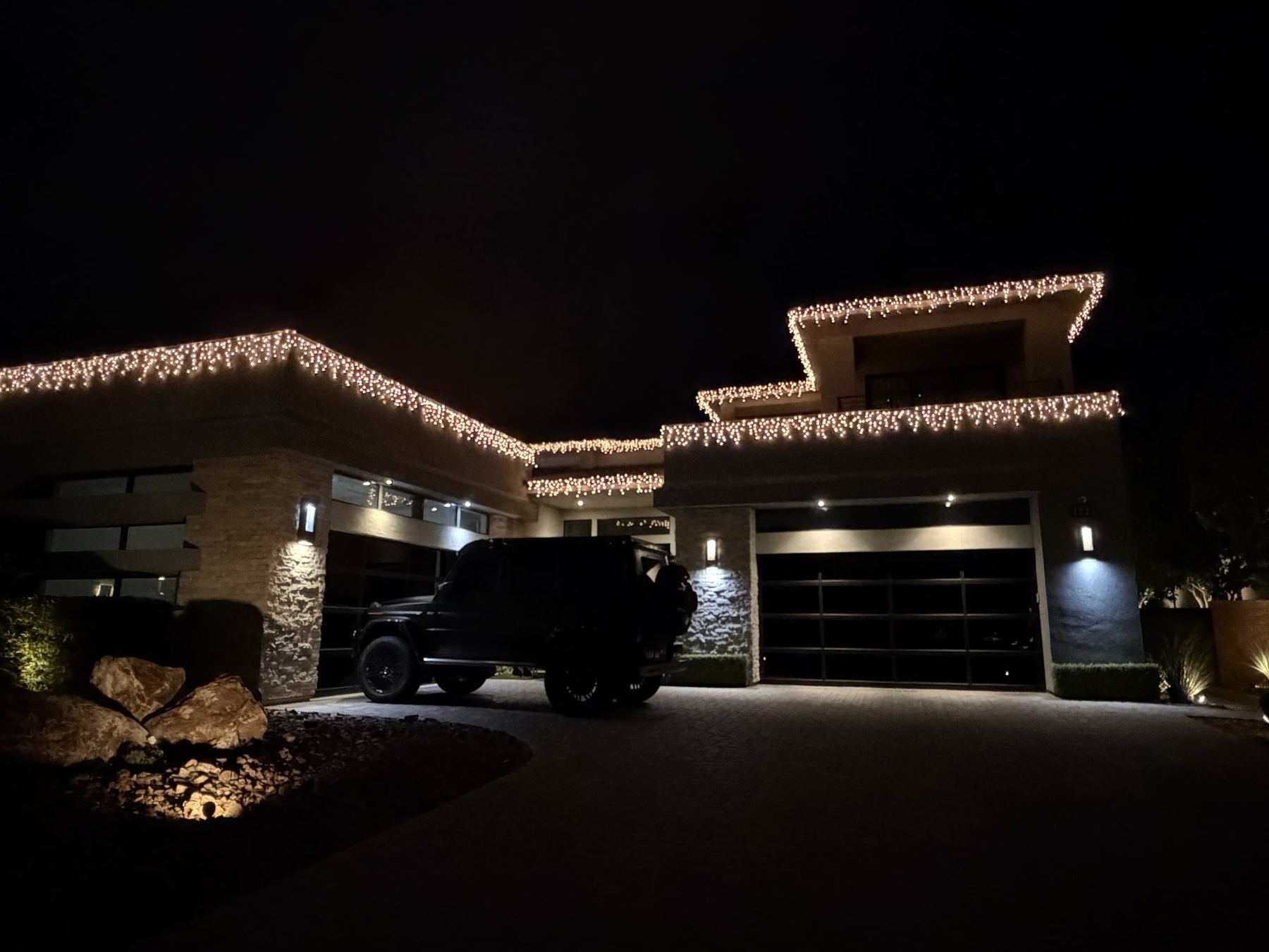 Christmas lights along a Summerlin roofline at night
